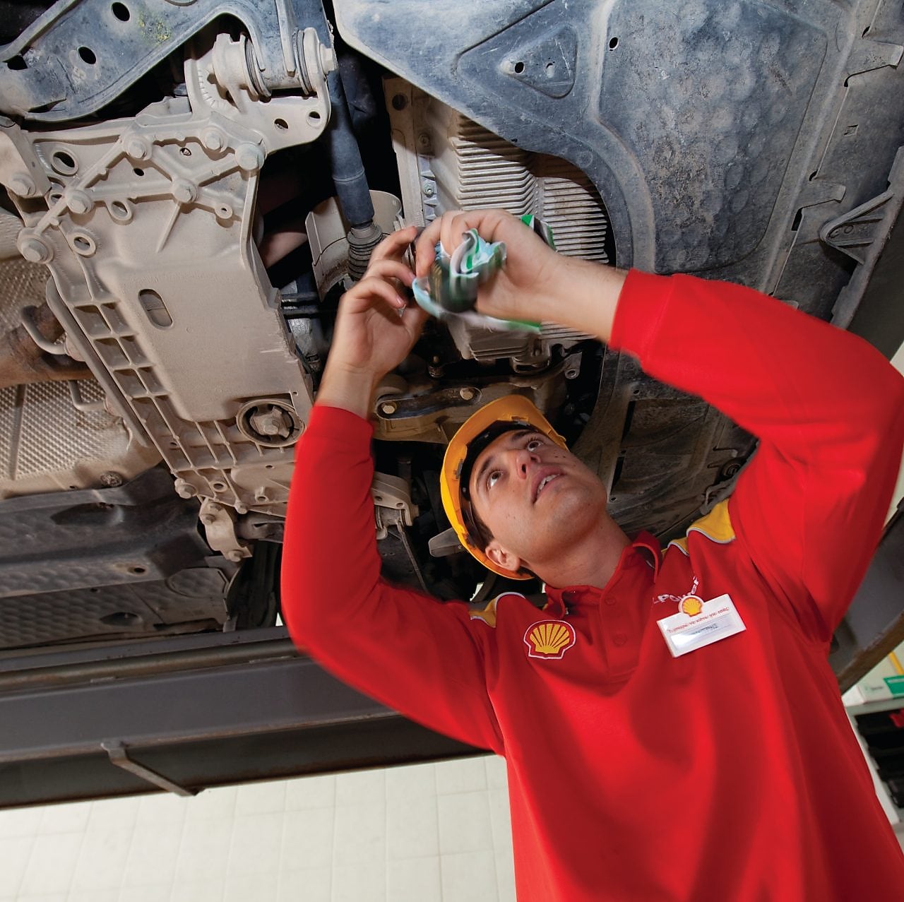 employee doing fitting of parts in car