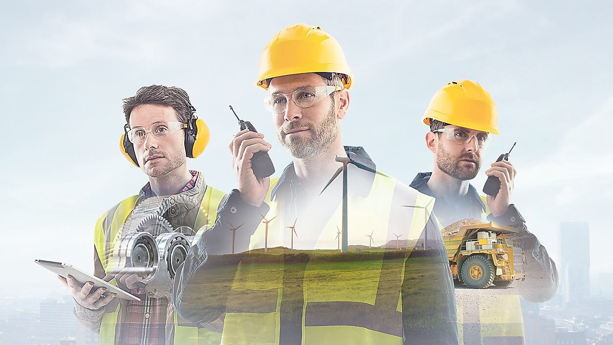 three workers on radios and reading documents, transposed over a background of blue sky with light clouds