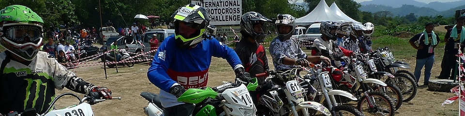 Motorcross motorcycles lining up at the start of a race