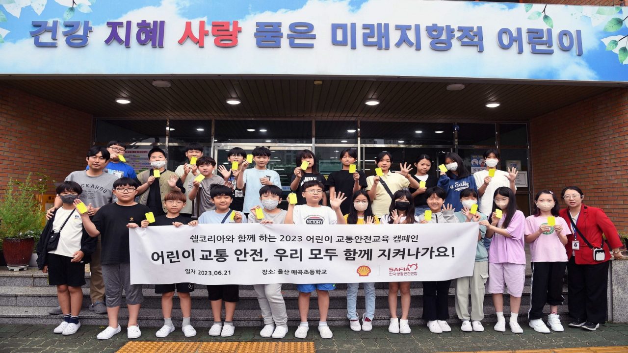 쉘코리아 2023 ‘아동교통안전교육 캠페인’ 첫 수업에 참여한 울산 매곡초등학교 6학년 학생들과 담임교사, 캠페인 지도교사가 어두운 밤이나 사각지대에서도 눈에 잘 띌 수 있도록 제작된 옐로카드(반사판)를 들고 기념사진을 촬영하고 있다.