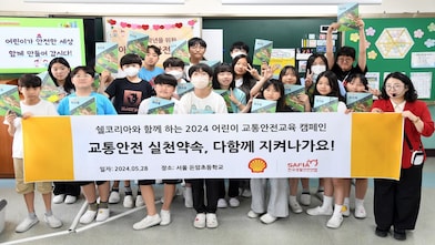  [사진1] 지난 28일 쉘코리아 2024 '아동교통안전교육 캠페인' 첫 수업에 참여한 서울 돈암초등학교 6학년 6반 학생들과 캠페인 지도교사가 워크북을 들고 기념사진을 촬영하고 있다.